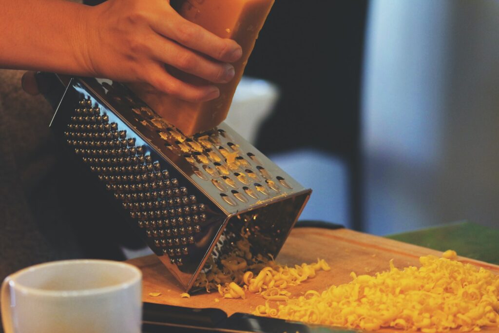 grating a hard cheese with a large  box grater