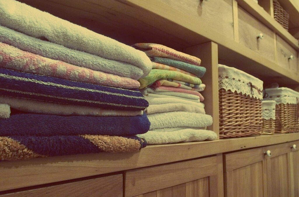 towels neatly folded in a timber storage area