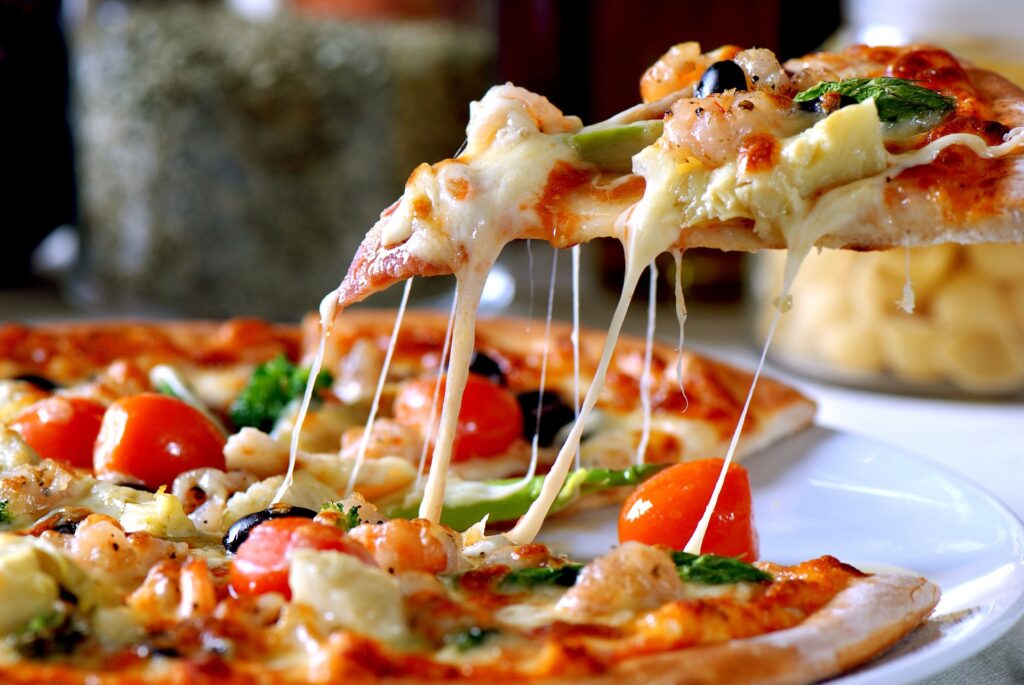 Delicious Thin Crust Pizza With Olives, Asparagus, Tomato and Cheese!