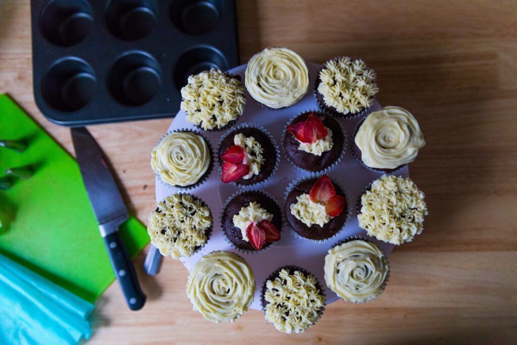 muffin tins, one empty, one filled with delicious cup-cakes